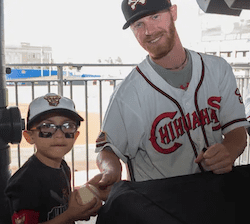 Derek, in his playing days, greets a young fan. Derek is one of many coaches who have turned to Finli's simple invoicing solution.